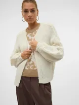 Cardigan de punto color crema, con cuello en V, mangas largas abullonadas, hombros caídos y puños acanalados.
