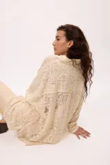 Camisa blanca oversize de algodón con cuello clásico, mangas largas y puños abotonados con detalle de tablas.