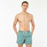 Short de baño verde con estampado geométrico en blanco y cordón ajustable en la cintura.