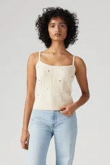 Musculosa de punto color crema con breteles finos y bordado de pequeñas estrellas de colores.