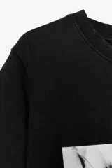 Remera negra de algodón con efecto lavado, cuello redondo y mangas cortas. Estampado frontal con imagen de Lady Gaga y texto "LVDY GAGA" y "MAYHEM".