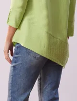 Blusa verde en tejido acanalado, marca Ruby Rd. Largo de mangas ¾ con abertura y botones. Terminación de ruedo asimétrico.
