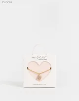 Cadena corta dorada con dije de la letra A cubierto de strass.