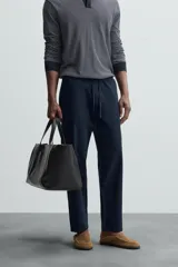 Pantalón azul marino de corte recto, con cintura elástica ajustable con cordón, bolsillos laterales y traseros.