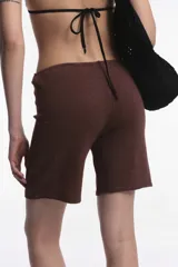 Short color blanco con textura de toalla y cordón ajustable en la cintura.