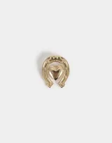 Pin dorado con forma de herradura y corazón.