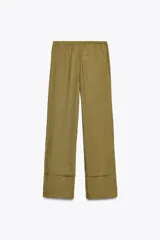 Pantalón palazzo color ladrillo confeccionado en lino 100%, de tiro medio con cintura ajustable con cordones, bolsillos laterales ocultos en costura y pierna ancha.