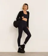 Top deportivo negro de microfibra con espalda estilo nadador y friso contrastante blanco.