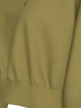 Buzo color verde oliva de corte boxy, con cuello redondo, puños y bajo de canalé. Logo escrito de Calvin Klein Jeans en el pecho.