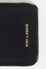 Monedero Bimba y Lola color gris claro, de nylon con estructura blanda. Tiene logo metálico de la marca, cierre con cremallera, tarjetero y monedero interior.
