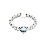 Pulsera elástica de bolas plateadas con un cristal facetado azul.