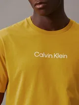Remera amarilla de algodón con cuello redondo y logo de Calvin Klein estampado en el pecho.