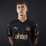 Camiseta de fútbol Puma del Club Atlético Peñarol, modelo Away 2025. Diseño negro con detalles dorados, escudo del club y logo de Puma en el pecho, sponsor Antel en el frente y BBVA en las mangas.