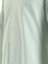Camisa de hombre Tommy Hilfiger de corte regular, con estampado de cuadros en tonos verde claro, verde oscuro y azul. Tiene cuello abotonado, mangas largas con puños abotonados y logo bordado en el pecho.