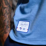 Camiseta de fútbol Umbro del Club Nacional de Football, modelo Away 3 temporada 2024. Diseño celeste con cuello polo blanco y detalles en rojo. Incluye logo de Umbro, escudo del club y sponsor Antel en el frente.