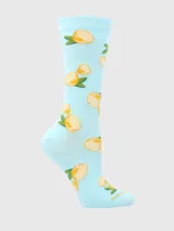 Calcetín largo medio de mujer, color celeste claro, con estampado de rodajas de limón y hojas verdes. El puño superior tiene un borde festoneado.