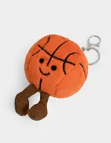 Llavero con dije de peluche en forma de pelota de básquet naranja con detalles bordados y piernas de peluche marrón.