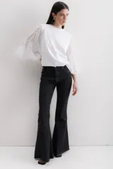 Blusa blanca de algodón con mangas largas abullonadas de gasa y puños elásticos.