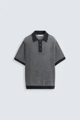 Polo de hombre de corte relajado, tejido de punto de algodón a rayas verticales en tonos gris y negro. Tiene cuello solapa, cierre frontal con botones y mangas cortas.