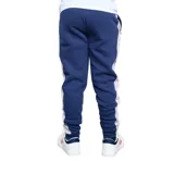 Pantalón de jogging azul marino con una franja blanca vertical en el lateral y logo de Umbro en blanco.