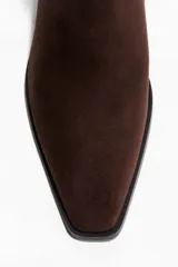 Botas Chelsea de gamuza color marrón oscuro, con punta cuadrada, elásticos laterales negros y taco cuadrado bajo.