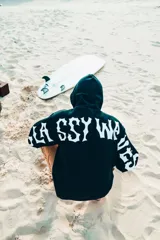 Buzo hoodie negro con estampa en la espalda y mangas con letras blancas.