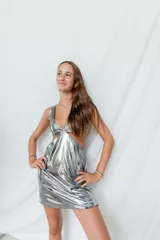 Vestido corto negro con escote en V, breteles finos cruzados en la espalda y cut-outs laterales bajo el busto.