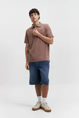 Polo marrón con textura y logo bordado.