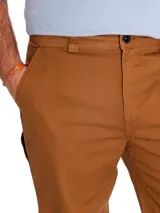 Pantalón de hombre color marrón, de corte recto, con cierre de cremallera y botón. Incluye bolsillos laterales, traseros tipo parche, trabilla para martillo y bolsillo utilitario en la parte trasera del muslo.