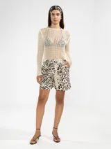 Sweater de tejido calado color crudo, con cuello bote y mangas largas.