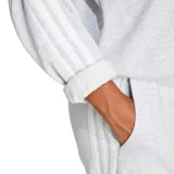 Buzo Adidas Essentials 3 Tiras gris melange de corte holgado, cuello redondo acanalado, hombros caídos, puños y dobladillo elásticos y las tres tiras características de la marca en color blanco a lo largo de las mangas.