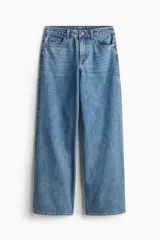 Jean de cinco bolsillos en denim de algodón rígido color celeste. Corte holgado en cintura y cadera con estilo baggy de muslo a bajo. Modelo de cintura clásica con cierre y botón y piernas rectas largas.