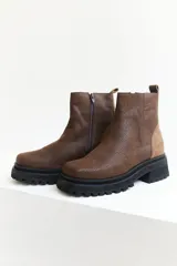 Botas cortas marrones de cuero con textura, suela track y cierre lateral con cremallera.