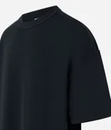Remera oversized de algodón color crudo, con cuello redondo, manga corta, sin estampa y ribete acanalado.