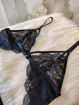 Conjunto de lencería de encaje en negro y blanco, con top con aro y tanga de doble tira regulable.