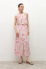 Falda midi de corte evasé con estampado paisley en tonos rosa, naranja y verde sobre fondo blanco.