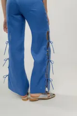 Pantalón negro de lino con aberturas laterales con cordones y bordado a contratono. Cuenta con un bolsillo trasero tejido a mano en crochet.