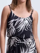 Vestido largo negro con estampado de hojas blancas, escote redondo, breteles finos regulables con detalle de cadena dorada.