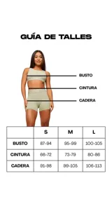 Top deportivo color beige con contorno negro, breteles anchos y logo pequeño en el frente.