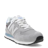Championes urbanos New Balance modelo 574, color gris con detalles en celeste y blanco, confeccionados en gamuza y malla, con logo "N" característico en los laterales y entresuela ENCAP.