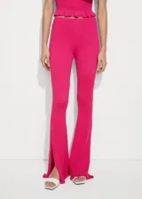 Pantalón acampanado color fucsia de tejido de punto trenzado con cintura elástica y aberturas en el ruedo.