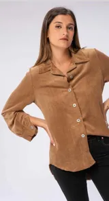 Camisa marrón de pana con cuello camisero, corte recto, mangas largas abullonadas con puños abotonados y cierre frontal con botones.