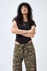 Body negro de punto canalé con mangas cortas, confeccionado en tejido suave y elástico que combina algodón, poliéster y elastano.