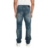Pantalón de jean color verde militar, de corte slim, con cinco bolsillos y logo CAT en la parte trasera.
