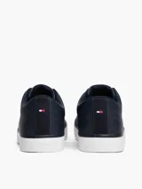Zapatillas de corte bajo Tommy Hilfiger confeccionadas en una mezcla de piel color azul marino. Presentan un diseño atemporal con cordones al tono, suela de goma vulcanizada blanca y detalles distintivos de la marca, incluyendo el logo en el lateral, la lengüeta y el talón bordado.