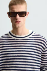 Jersey de punto con rayas horizontales azul marino y blanco, cuello redondo y manga larga.