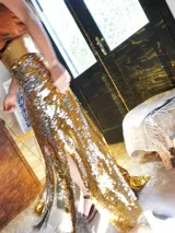 Pollera larga negra de lentejuelas con tajo lateral y cintura alta.