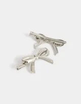 Set de dos hebillas plateadas para el pelo con forma de moño.