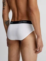 Pack de tres slips Calvin Klein en colores negro, blanco y gris, con cintura elástica negra con logo de la marca.