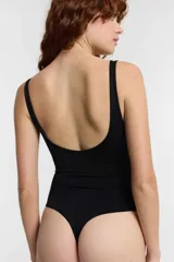 Body marrón con estampado animal print, sin aro ni copa, con breteles finos y cierre inferior con botones a presión.